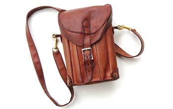 Photograph showing a small hand-stitched leather sketching bag with a buckle on a white background.