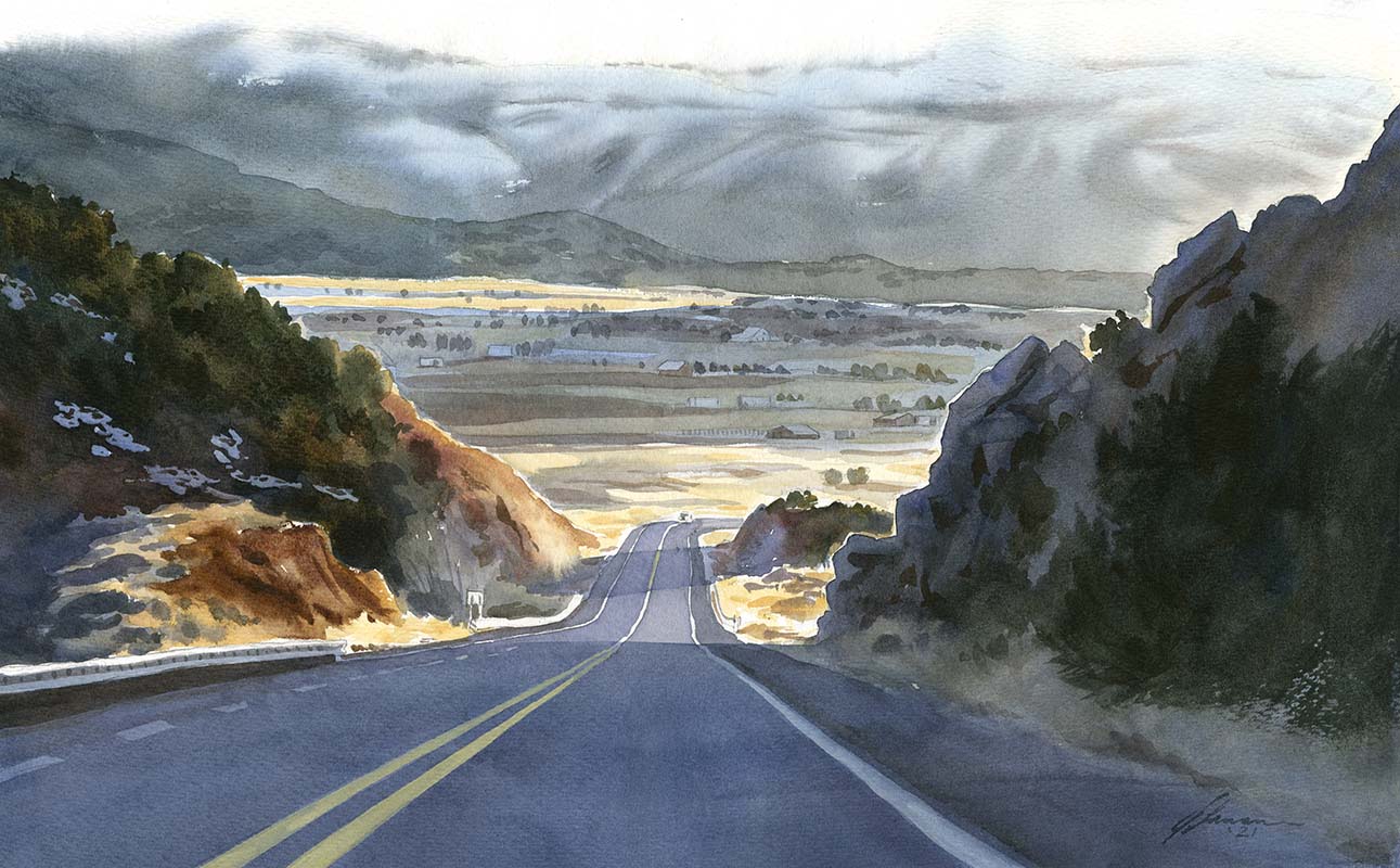 Watercolor painting of a road in shadow descending a hill with a sun-streaked valley and mountains in the distance.